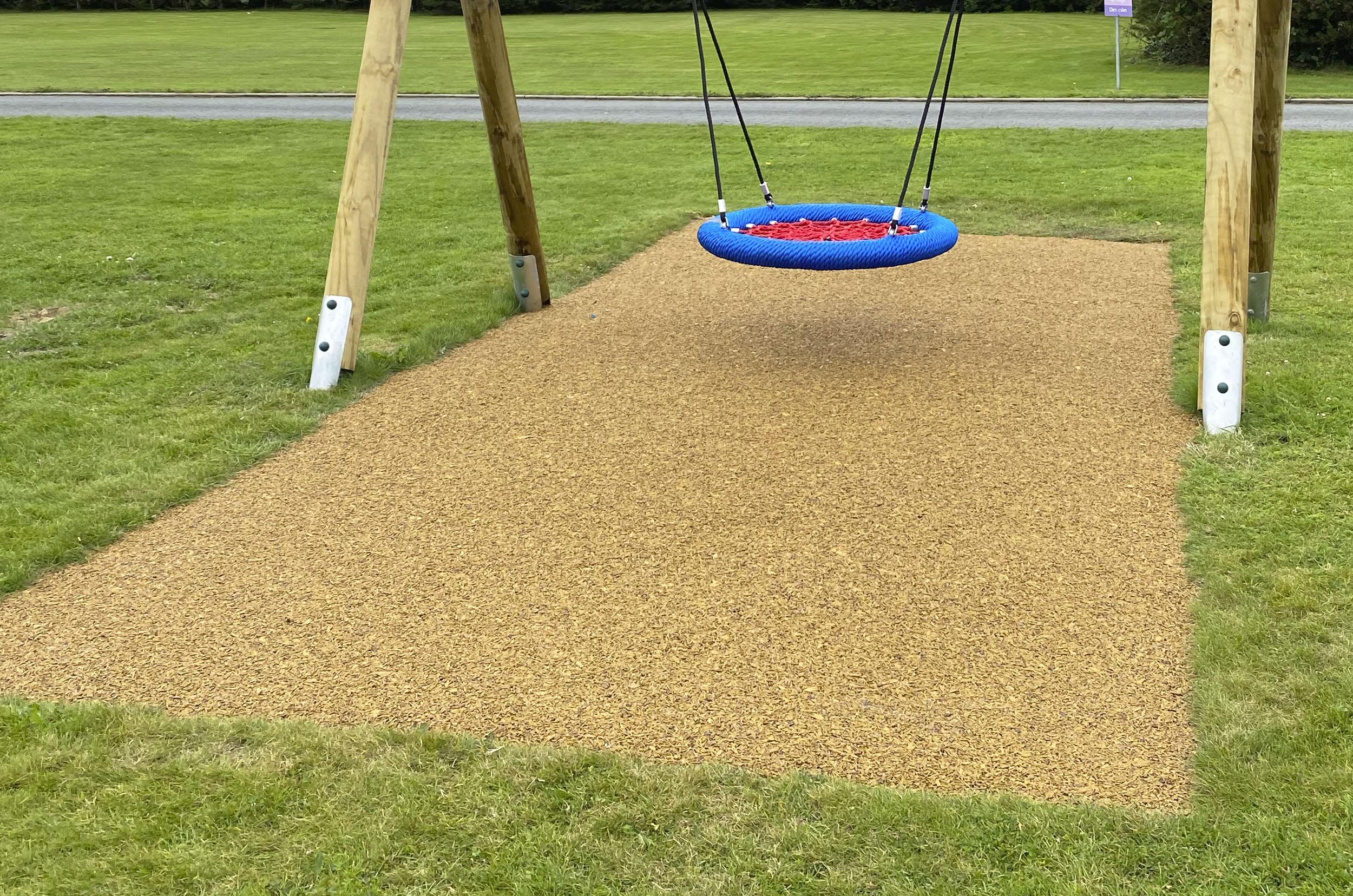 Mulch Wetpour Safer Surfacing - Harvest Beige well a timber swing with blue and red basket seat