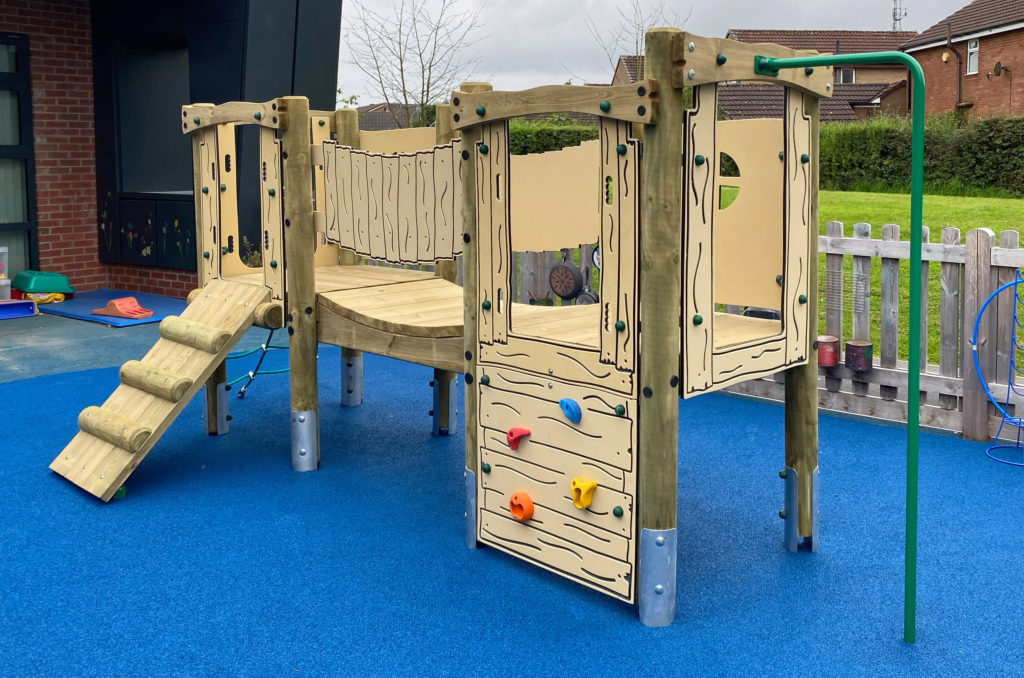 Ladygrove School - Timber climbing frame sits on blue wetpour safer surfacing