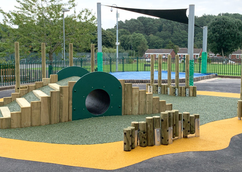The Woodlands Primary School - Play Tunnel surrounded by adventure trail on black yellow and green wetpour safer surfacing